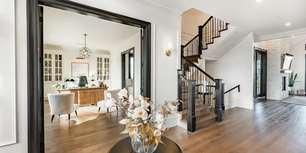 Modern home interior with office and staircase.