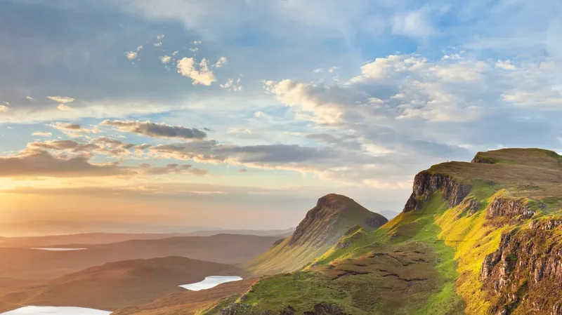 Sunlit mountains and sky during sunset.